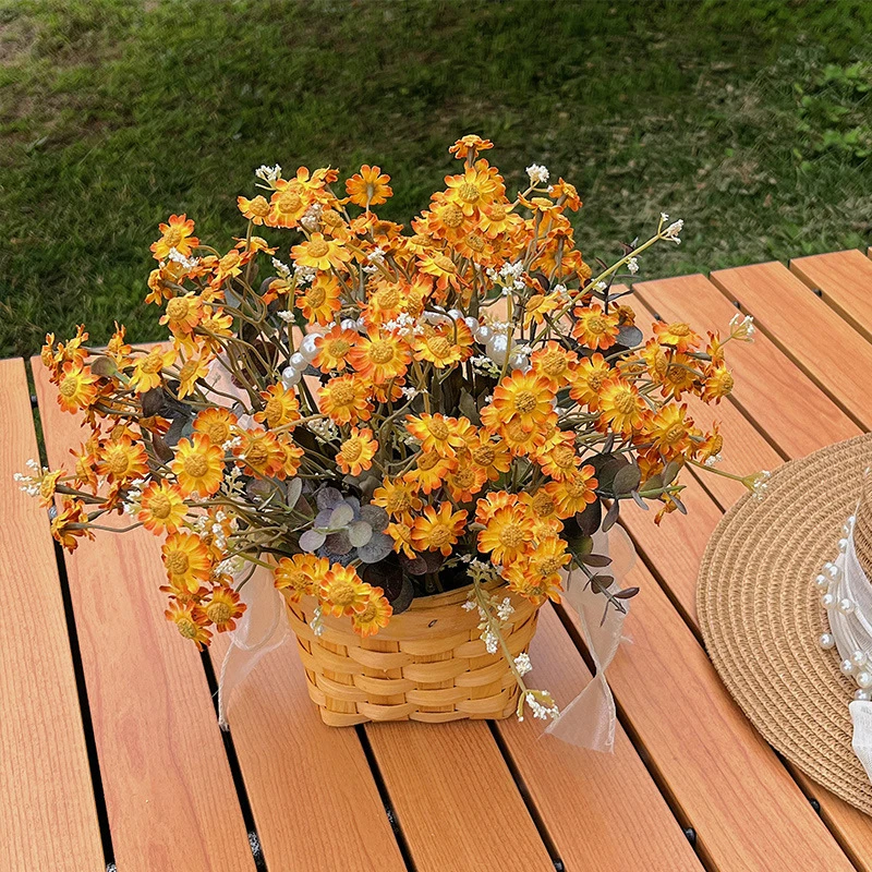 Marigold daisy artificial daisy plant in a basket massed into a dense dome, styled on a table top