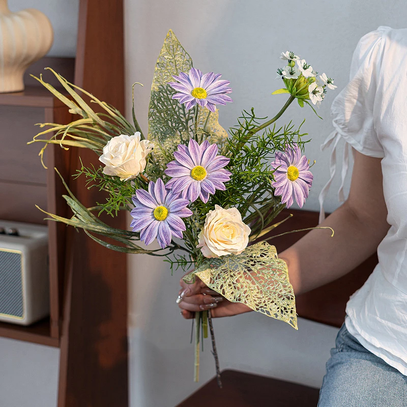 Artificial daisy and skeleton leaf posy with lace-veined skeleton leaves, styled in a room setting
