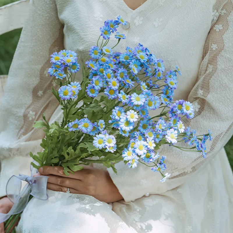 Blue artificial daisy spray stem with open blooms, buds and feathery foliage with the full colour range