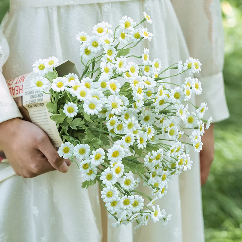 White artificial daisy spray stem with open blooms, buds and feathery foliage with the full colour range