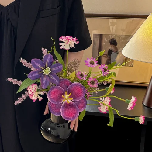 Small artificial flower posy sized for a bud vase, styled in a room setting