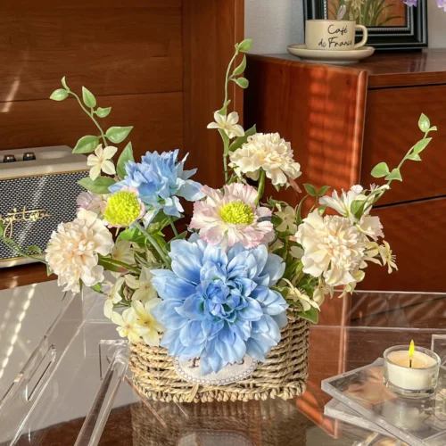 Blue dahlia artificial flower pot arrangement in a woven basket pot, styled in a room setting