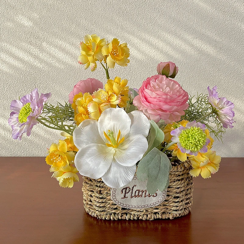 Yellow and pink artificial flower pot arrangement in a woven basket pot