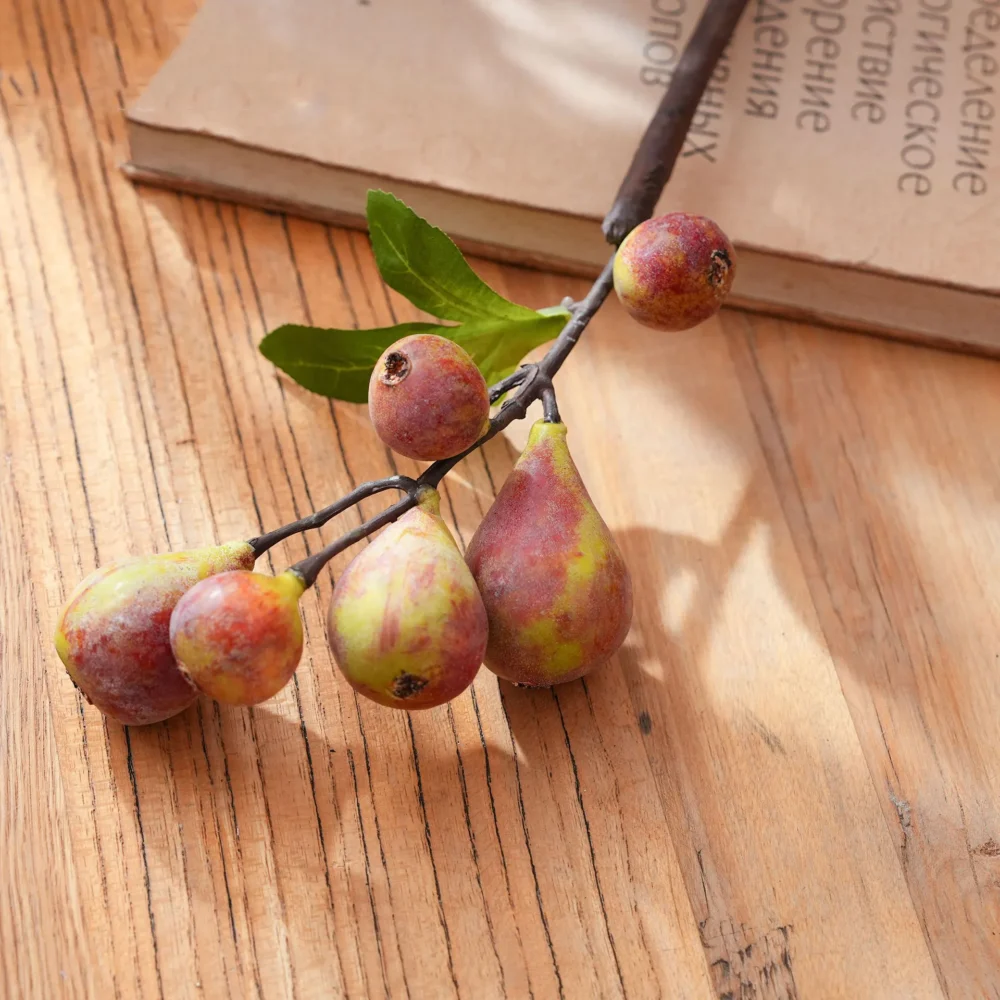 Blush artificial fruit branch with figs and berries on a woody stem, styled on a table top