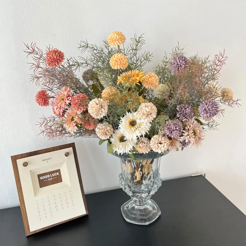 Artificial gerbera and pompom bunch in muted cream and caramel, arranged in a vase