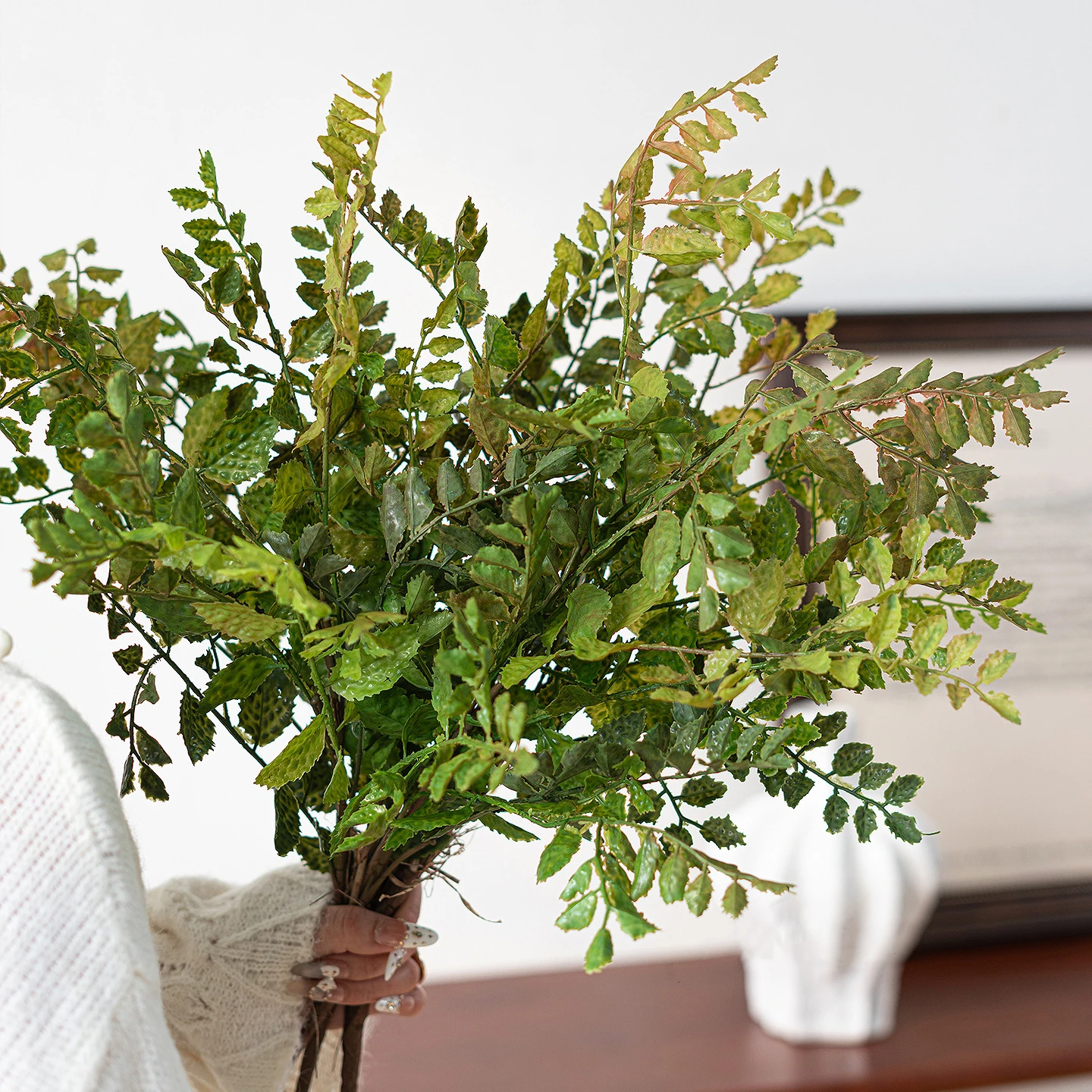 Bronze tinted artificial maidenhair fern stem on fine black wire stems, styled on a table top