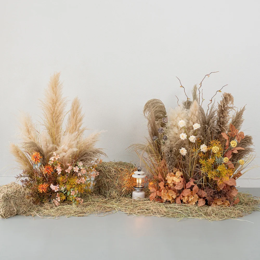 Artificial pampas grass arrangement built as a floor-standing installation, styled on a table top