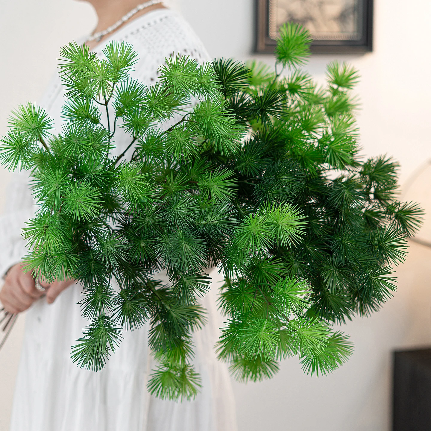 Artificial pine branch with soft needled side shoots on a brown stem with the full colour range