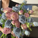 Artificial rose spray stem with three heads at three stages of opening with the full colour range