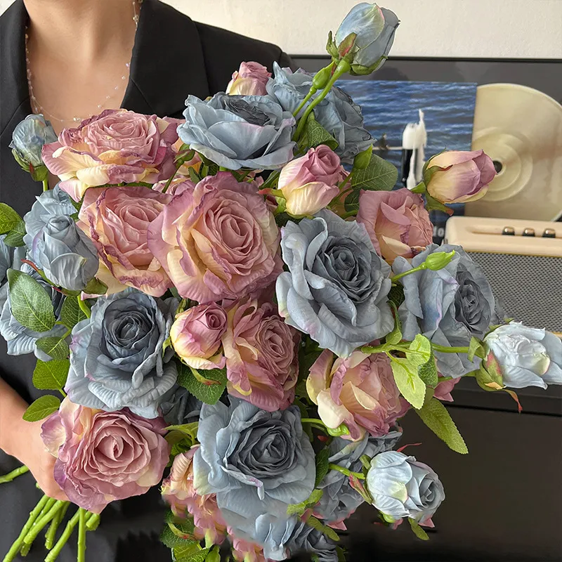 Artificial rose spray stem with three heads at three stages of opening with the full colour range