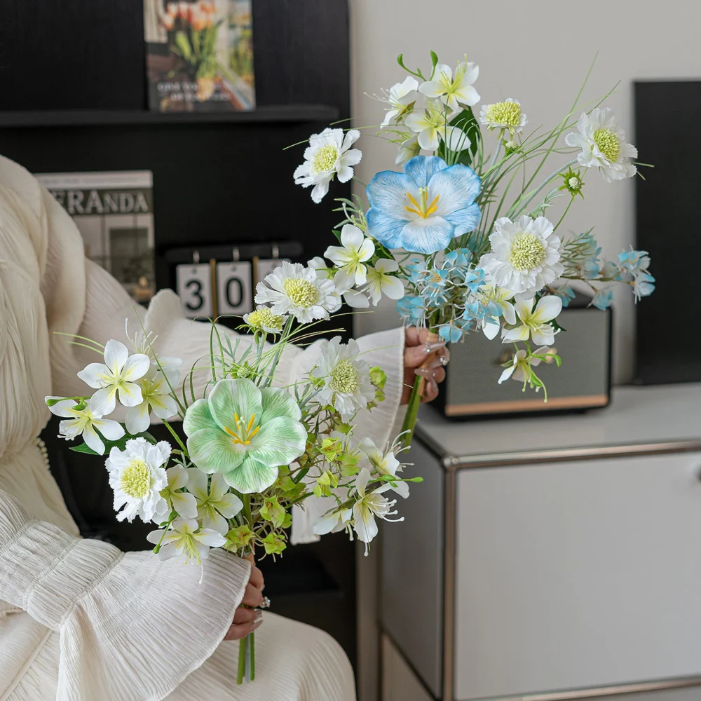 Sky blue artificial spring bouquet in blue and white of blue poppies, white blossom and fine grasses, styled in a room setting