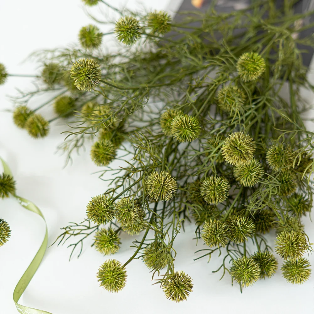 Artificial thistle stem with spiked round seed heads on wiry branching stems shown close up