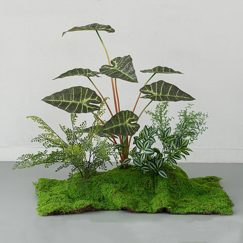 Striped leaf artificial tropical plant display on a wide moss floor