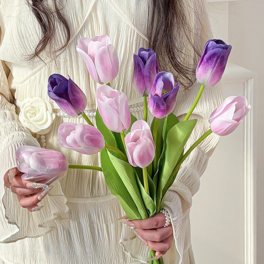 Lilac artificial tulip bunch of ten stems, ten stems tied as a market bunch, held in one hand