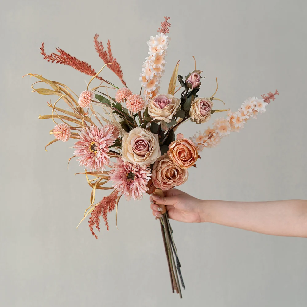 Blush artificial boho wedding bouquet in rust and terracotta with pampas and palm fans, held in one hand
