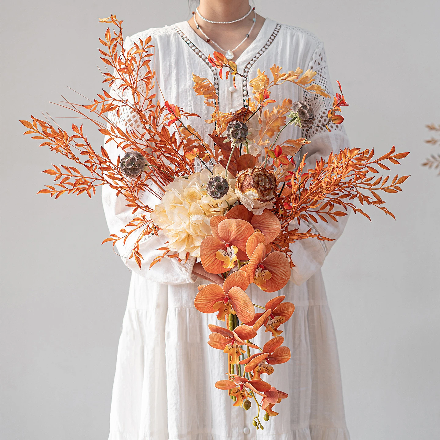 Artificial boho wedding bouquet in rust and terracotta with pampas and palm fans with the full colour range