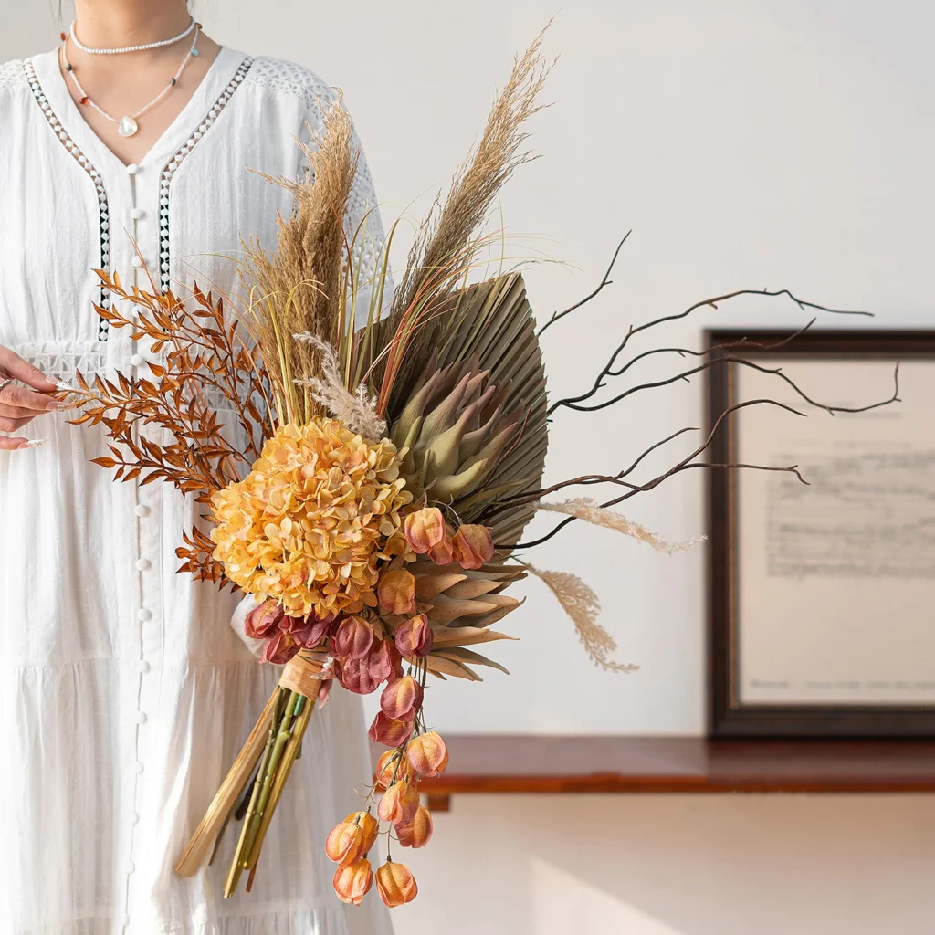 Dried-look artificial flowers arranged in a boho wedding bouquet