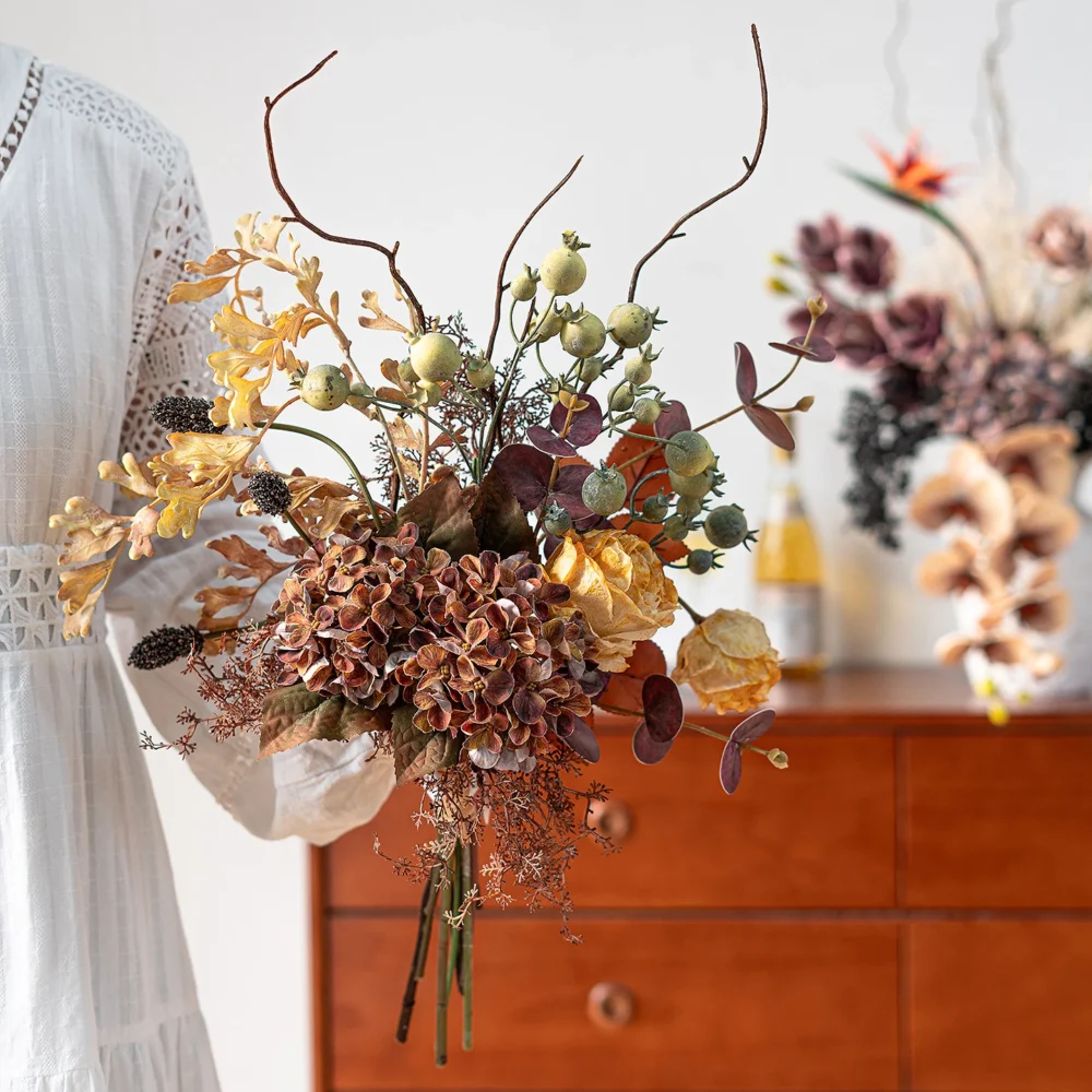 Artificial boho wedding bouquet in rust and terracotta with pampas and palm fans, styled on a table top