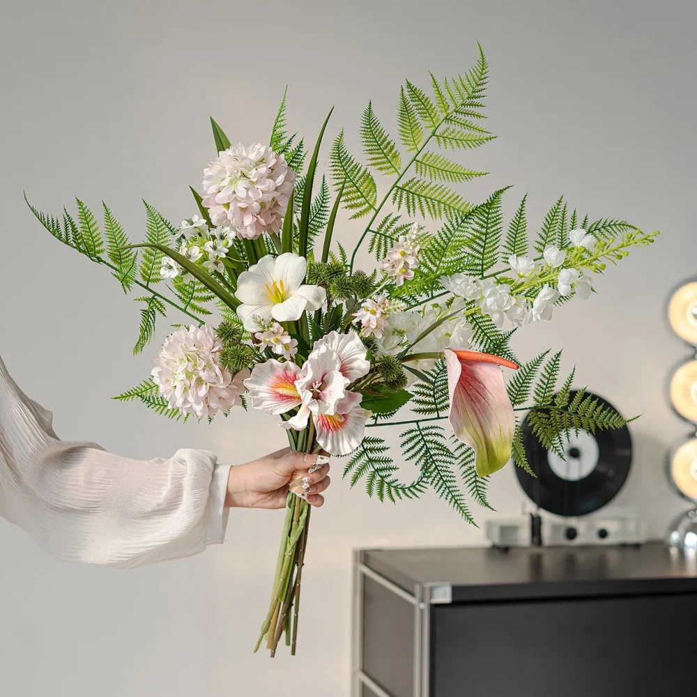 Blush and fern botanical artificial flower bouquet of orchids, calla lilies, caladium leaves and ferns, held in one hand