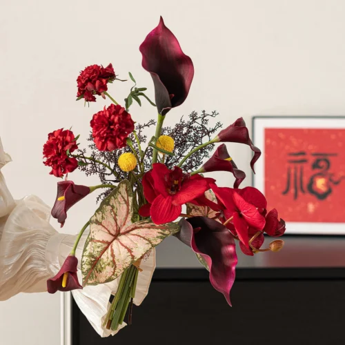 Aubergine calla artificial Chinese New Year bouquet wrapped in cream paper, styled on a table top