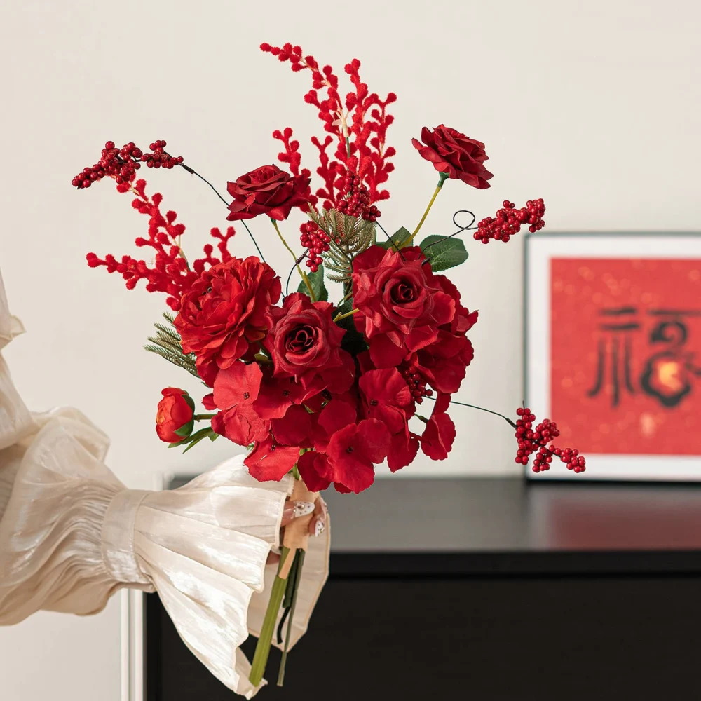 Rose and celosia artificial Chinese New Year bouquet wrapped in cream paper, styled on a table top