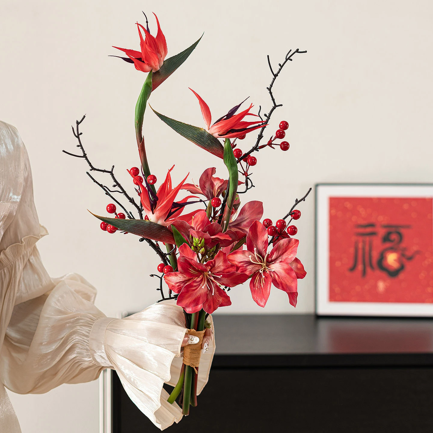 Strelitzia artificial Chinese New Year bouquet wrapped in cream paper, styled on a table top
