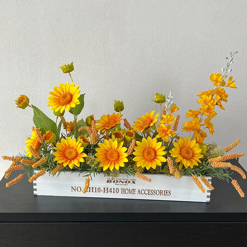 Sunflower artificial dining table centrepiece in a long white wooden trough, styled on a table top