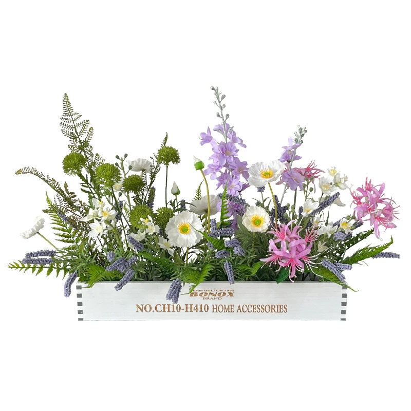 Artificial dining table centrepiece in a long white wooden trough