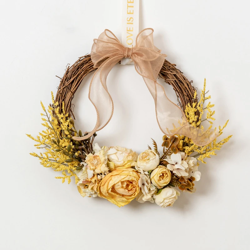 Yellow artificial dried flower wreath on a bare twig ring