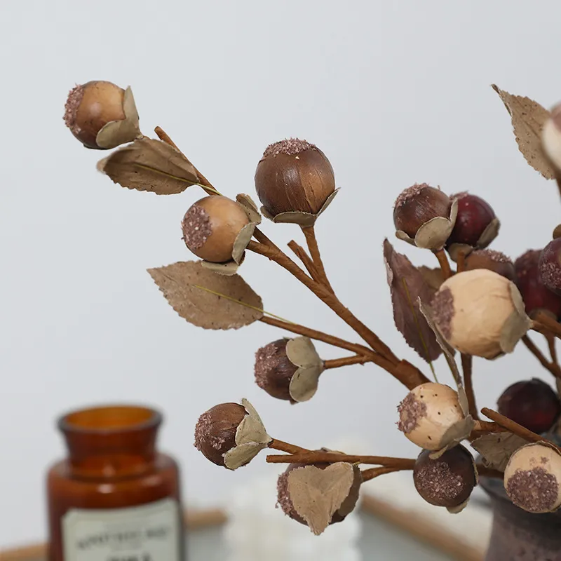Sand dried look artificial berry stem with matt berries and leather-textured leaves, arranged in a vase