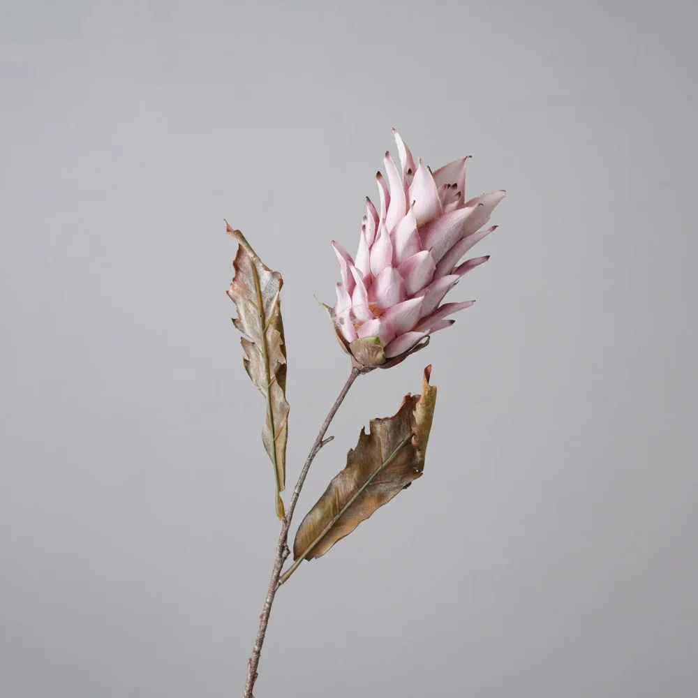 Pale pink dried look artificial protea stem with layered bracts and long leaves