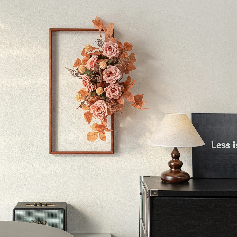 Blush rose artificial floral wall art frame on an open wooden frame, styled in a room setting