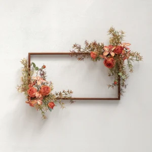 Artificial flowers arranged around a wooden frame for botanical wall art