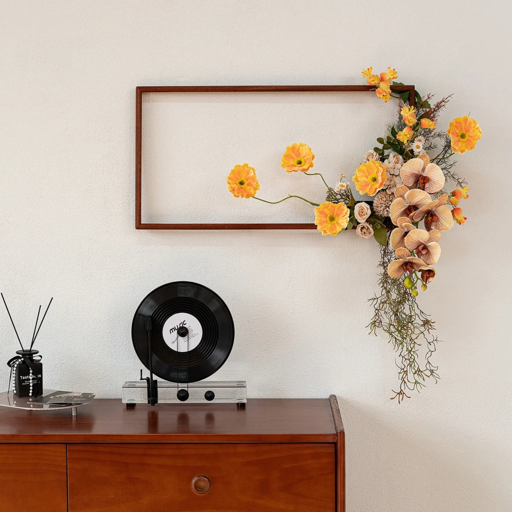 Yellow trailing artificial floral wall art frame on an open wooden frame, styled in a room setting