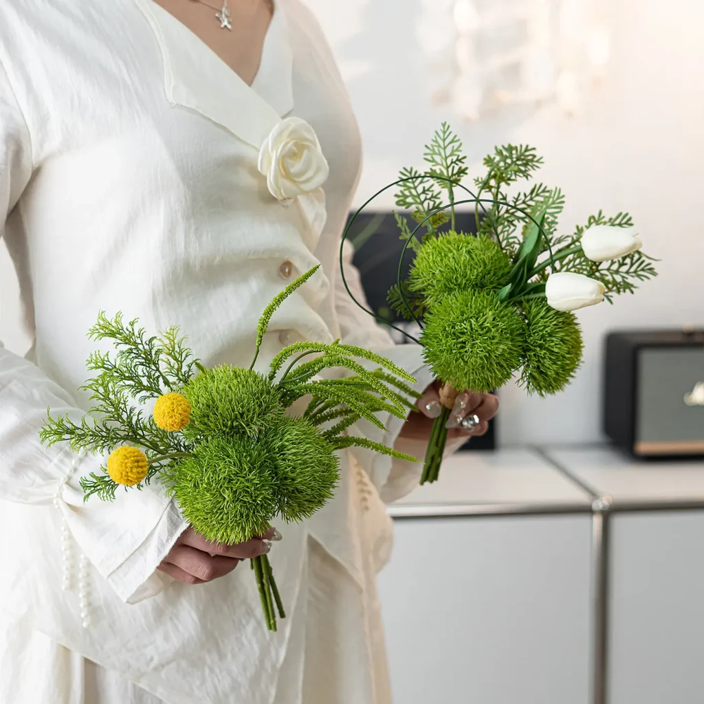 White rose green artificial wedding bouquet of green dianthus balls and yellow billy buttons, held in one hand