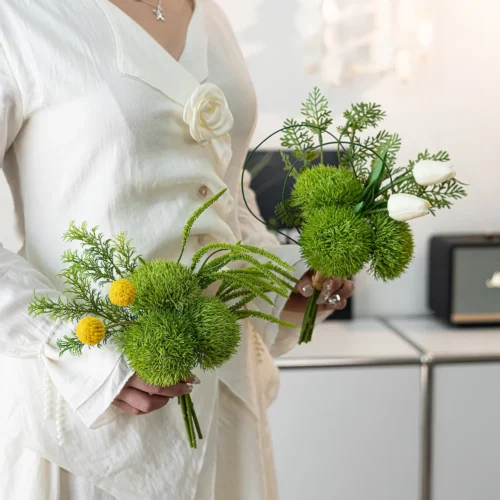 White rose green artificial wedding bouquet of green dianthus balls and yellow billy buttons, held in one hand