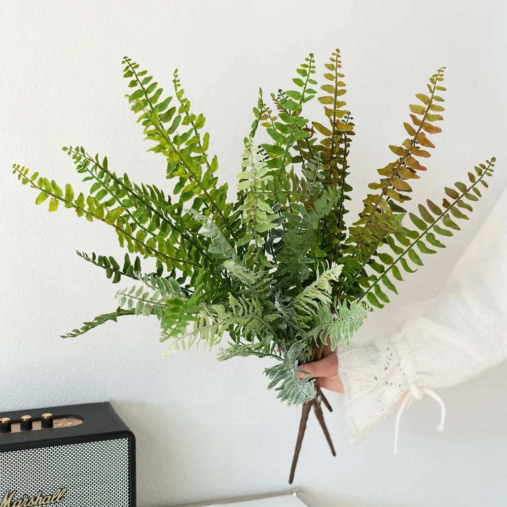 Bronze tipped large artificial fern frond, sixty centimetres from base to tip, styled on a table top