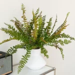 Green large artificial fern frond, sixty centimetres from base to tip, arranged in a vase