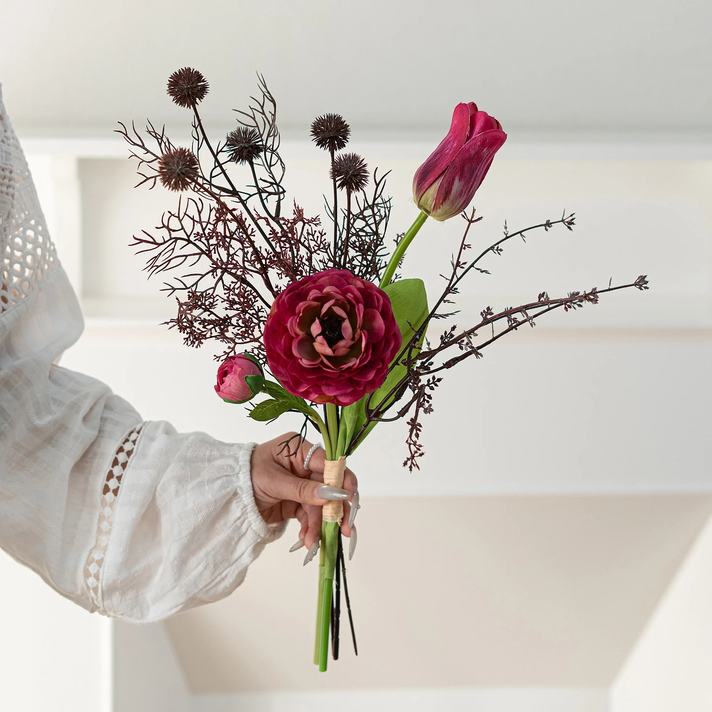 Magenta peony artificial mini flower bouquet of three or four stems tied at the base, held in one hand
