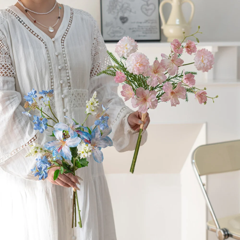 Artificial mini flower bouquet of three or four stems tied at the base, styled in a room setting