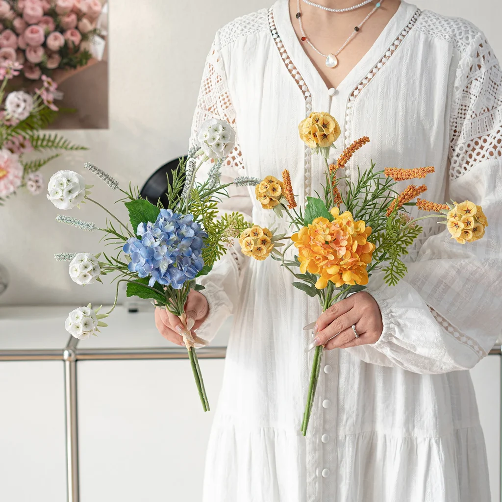 Artificial mini flower bouquet of three or four stems tied at the base, styled on a table top