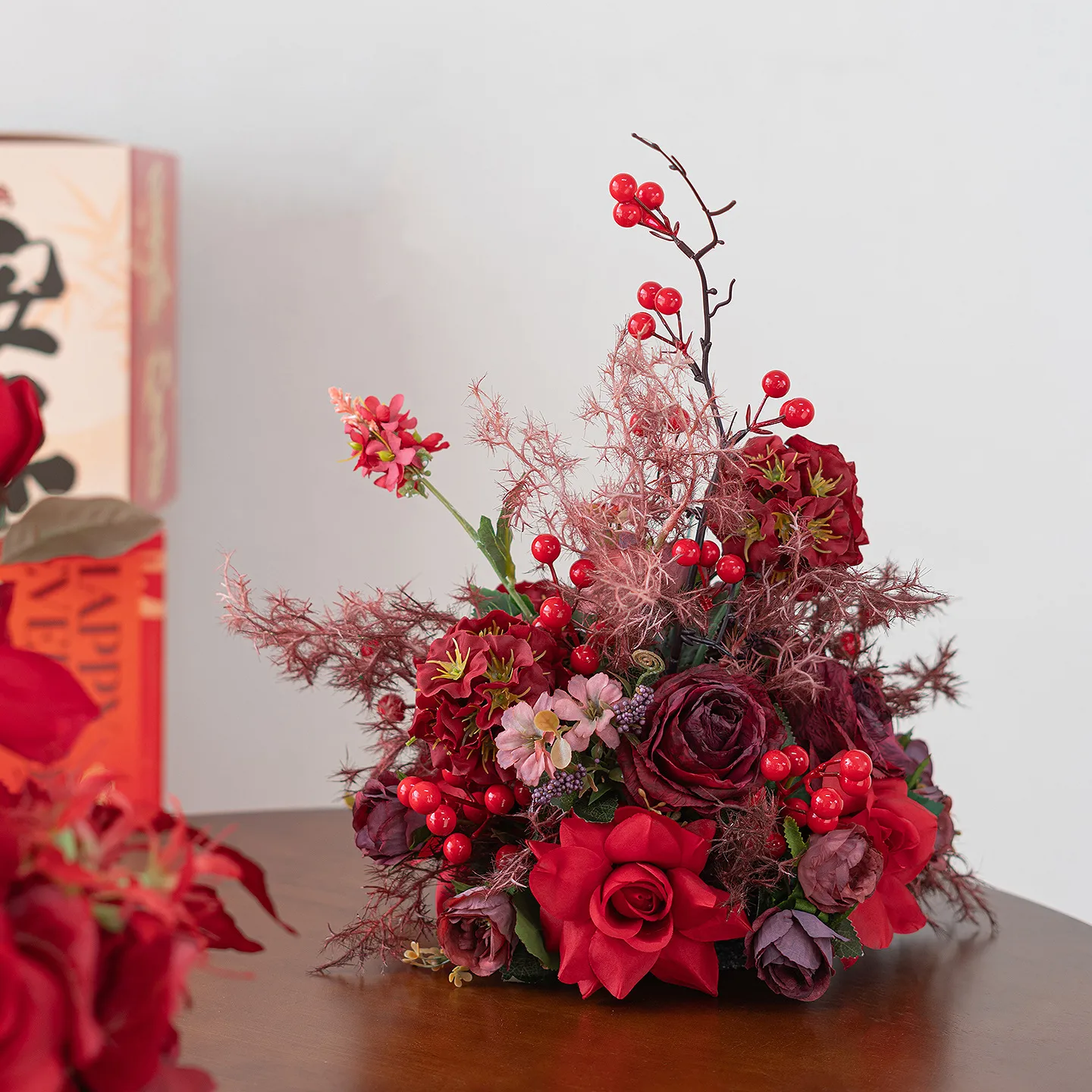 Red rose red artificial flower table arrangement in a low black base
