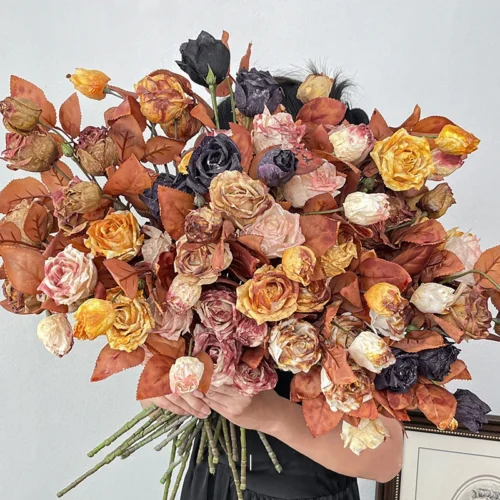 Vintage artificial rose stem with three dried-look heads and rust foliage with the full colour range
