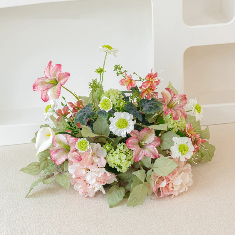 Blush artificial wedding arch arrangement built long and low as a one-sided run, styled on a table top