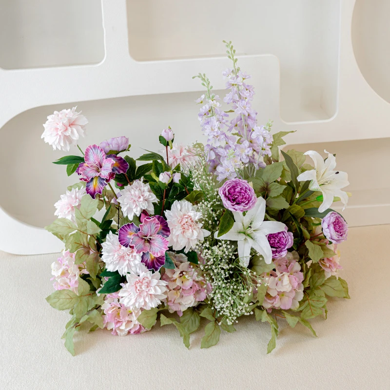 Plum artificial wedding arch arrangement built long and low as a one-sided run, styled on a table top