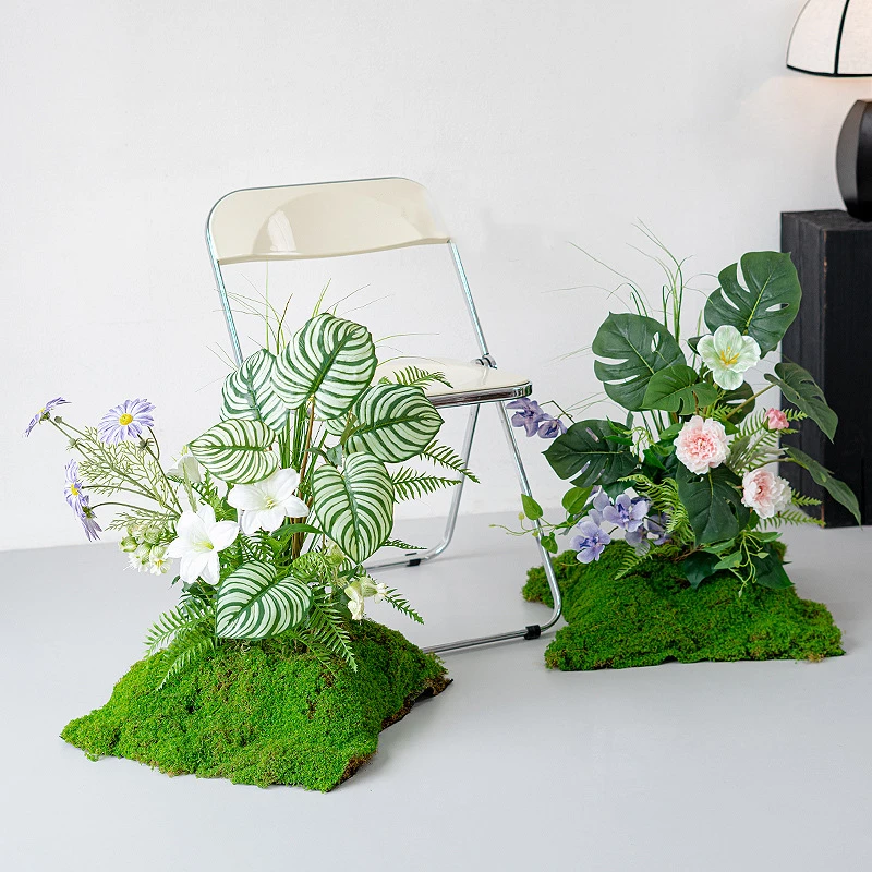 Large artificial woodland arrangement on a wide moss base, styled in a room setting