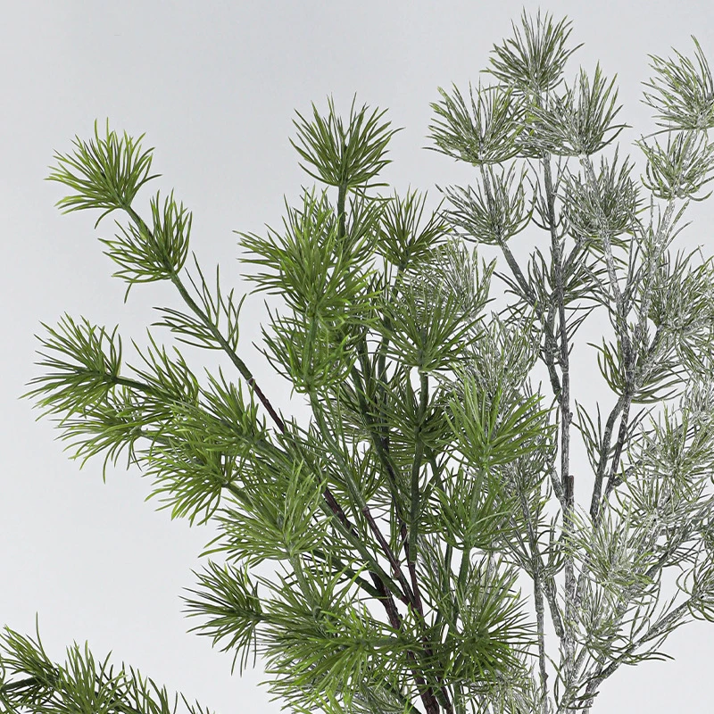 Green and frosted tips artificial Christmas foliage spray shown close up