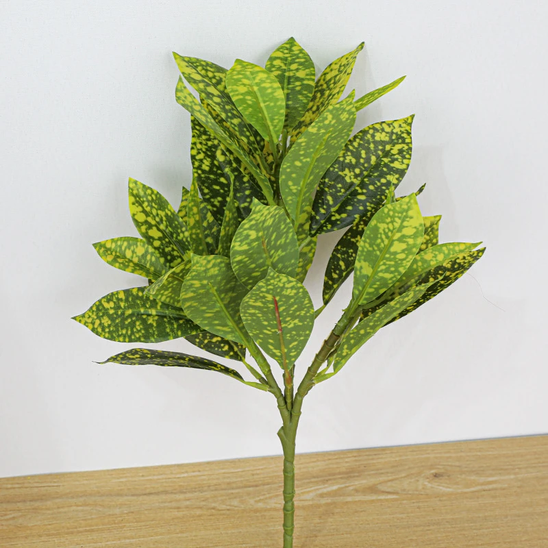 Yellow spotted artificial croton leaf stem with leathery leaves marked in two or three colours