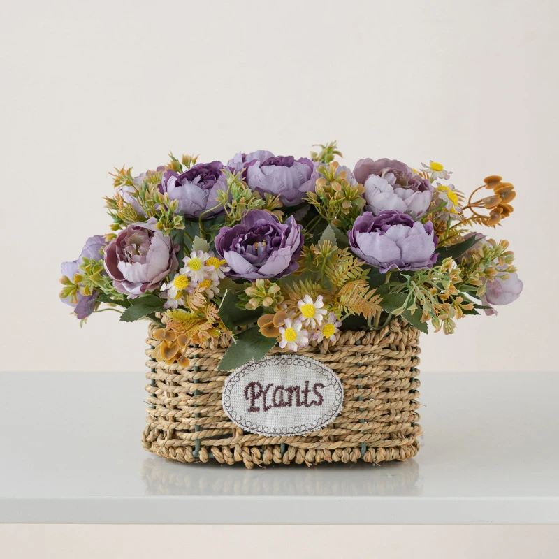 Lilac peony artificial flower basket, oval woven in an oval woven basket with a ceramic tag, styled on a table top