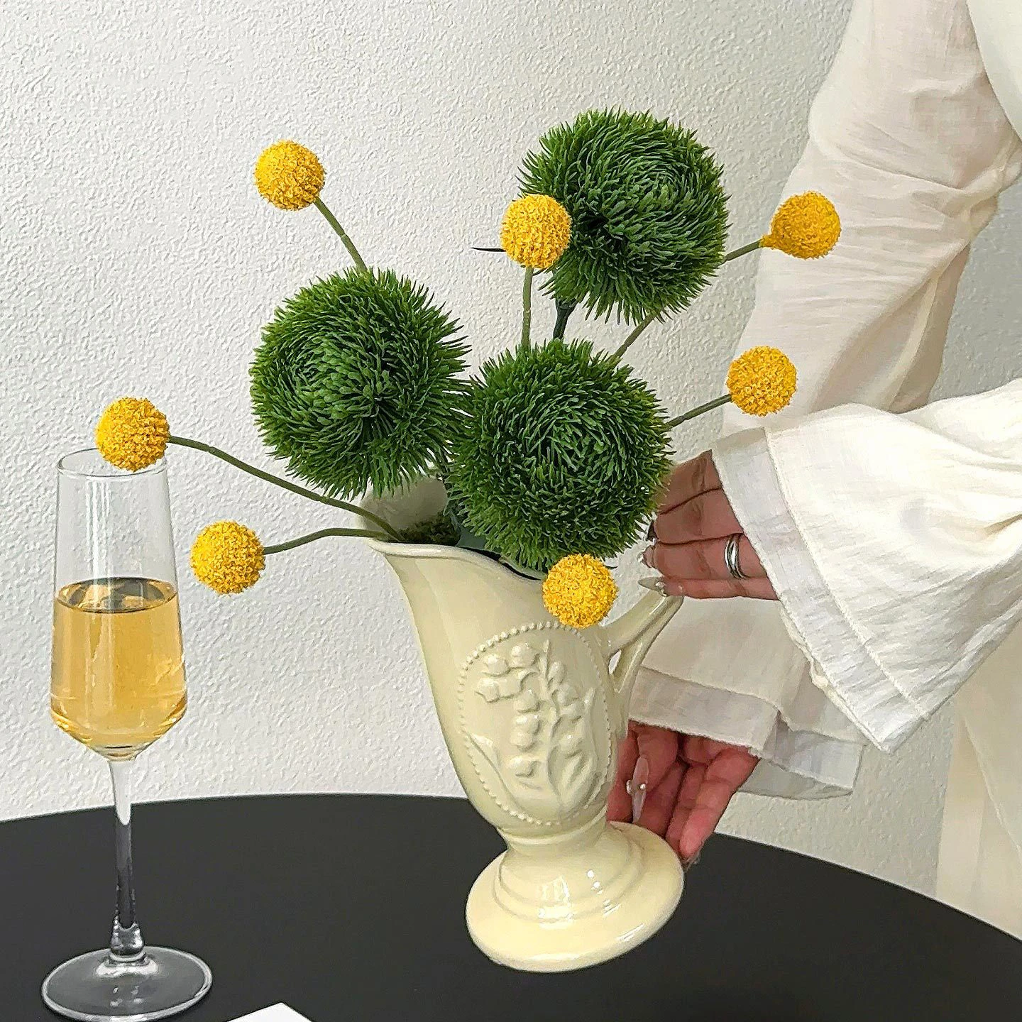 Cream embossed jug artificial flower arrangement in a white vase, two flowers only, in a choice of four vessels, held in one hand